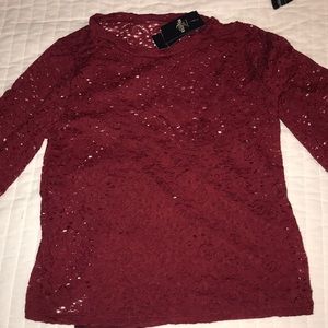 A lace shirt with matching undershirt attached.
